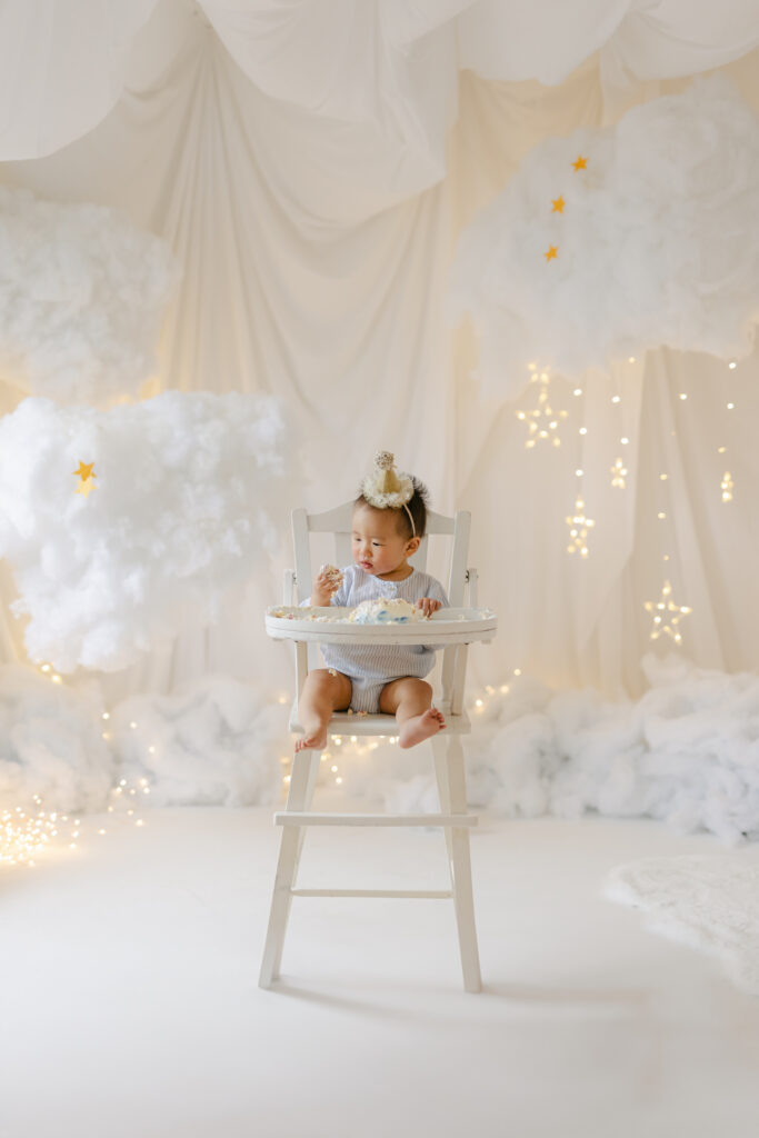 A cake smash session in Toronto while the baby eats his cake