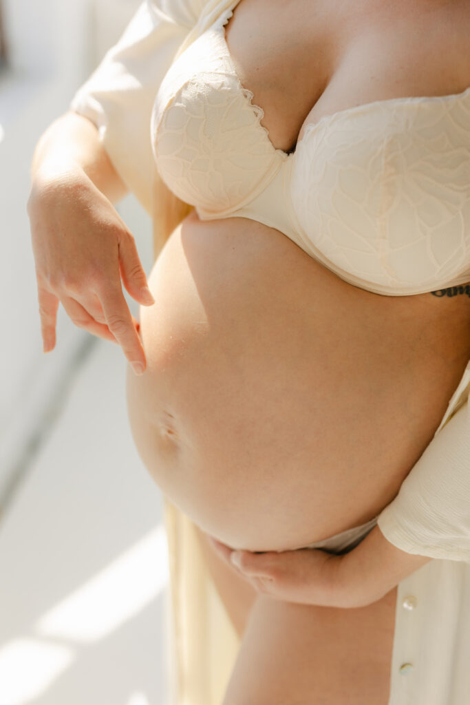 an expecting mother massaging her pregnant belly in Toronto